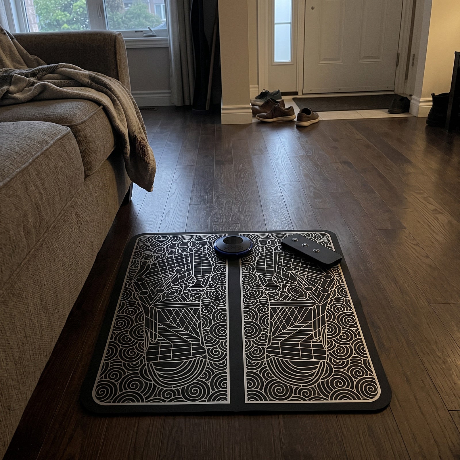 FootPause mat stored beside a sofa at dusk